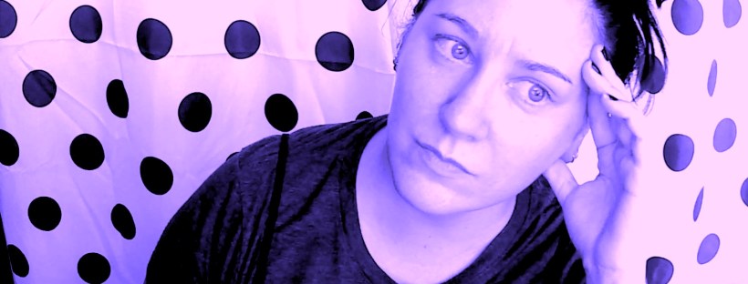 Cami sitting in front of a polka dot curtain looking anxious